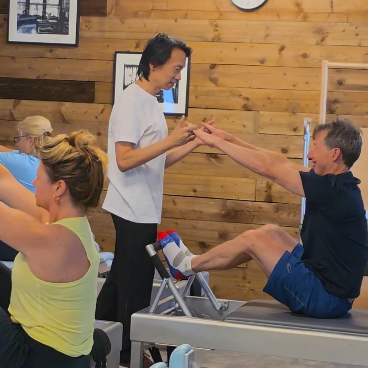 Andrew teaching a small group on the Reformers at Pilates From Within, Haslemere