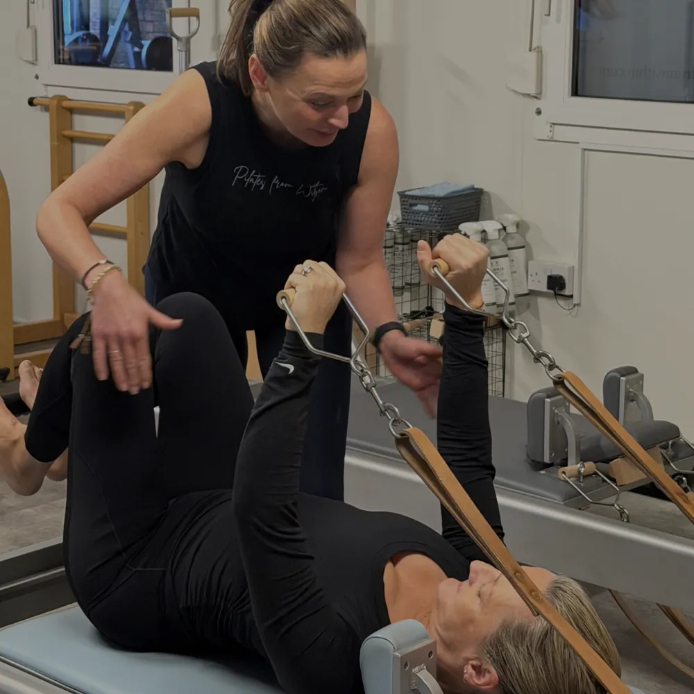 Karen guiding a client on the Reformer at Pilates From Within, Haslemere