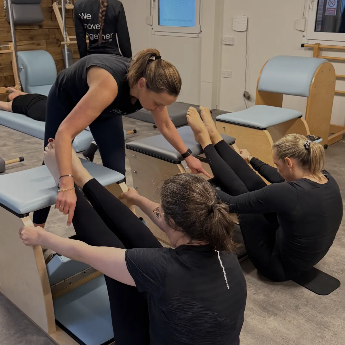 A teacher guiding clients on the Wunda Chairs at Pilates From Within, Haslemere